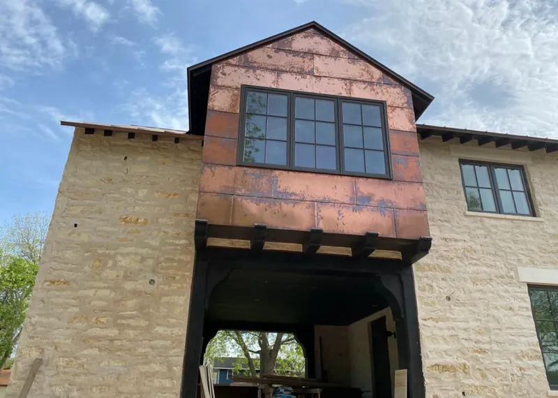 Copper metal panel facade on a stone building for Skylight Installation in Vidalia