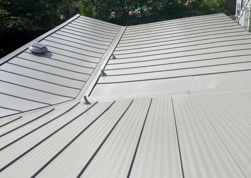 Solar attic fan installed on a metal roof for Roof Ventilation in Vidalia